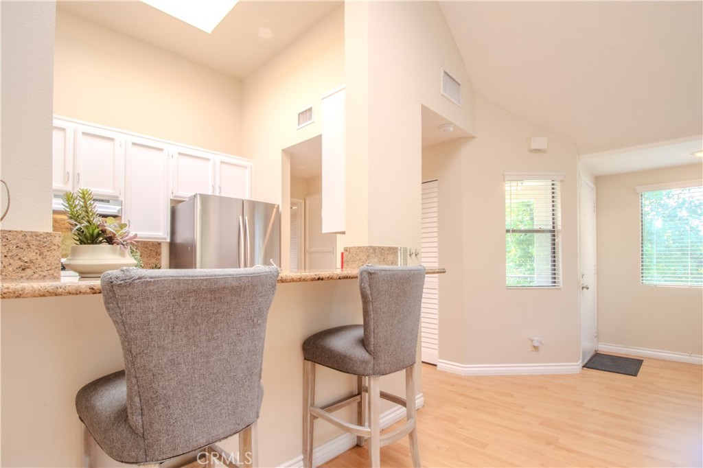 Kitchen with Bar Top and Seating - 5744 E Creekside 21, Orange CA 92869 - photo 19