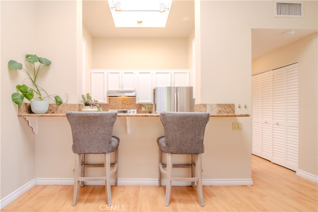 Kitchen with Bar Top and Seating - 5744 E Creekside 21, Orange CA 92869 - photo 21
