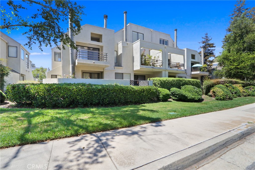 Surrounded by lush landscaping and view of greenbelt - 5744 E Creekside 67, Orange CA 92869 - photo 1