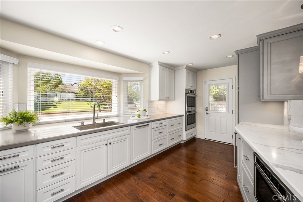 The gathering place for family and friends, exterior door to side yard, large pantry with pull out shelves - 6703 E La Cumbre, Orange CA 92869 - photo 22