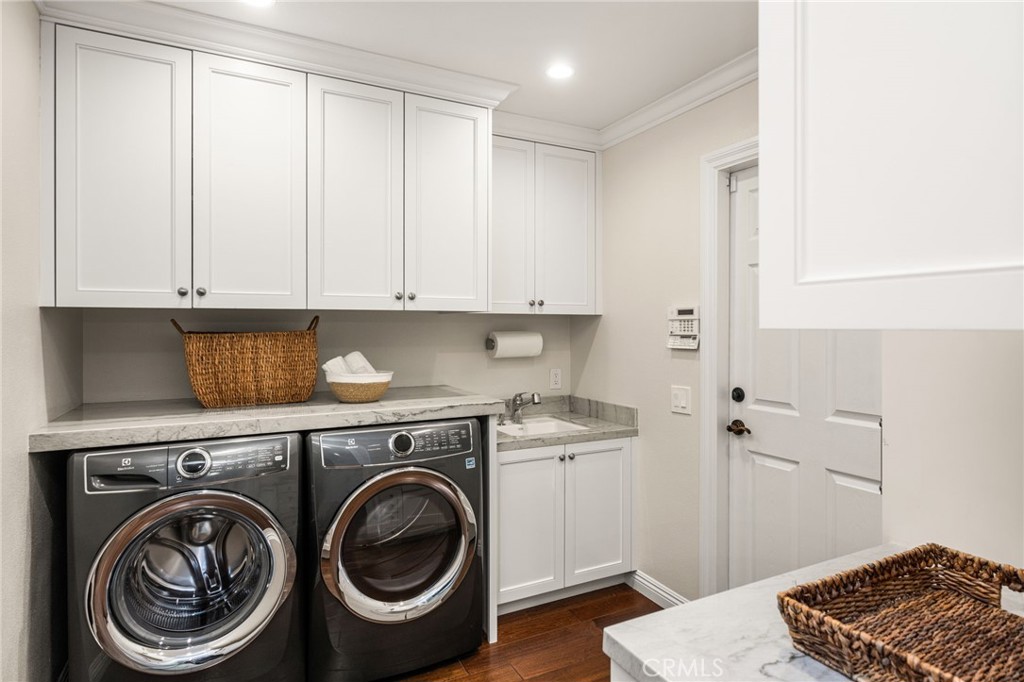Indoor Laundry with luxurious quartzite counters, with built in sewing center and instant hot water at the sink - 6703 E La Cumbre, Orange CA 92869 - photo 54
