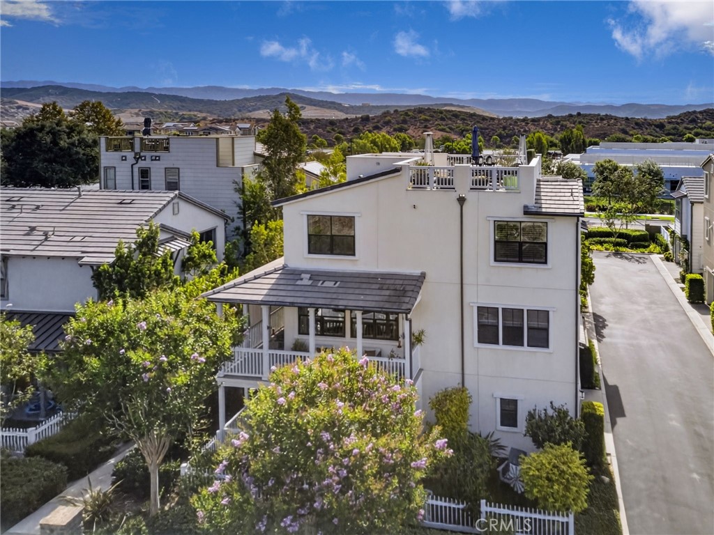 View of the house with the rooftop deck and spacious yard with white picket fence. - 14 Marisol, Rancho Mission Viejo CA 92694 - photo 7