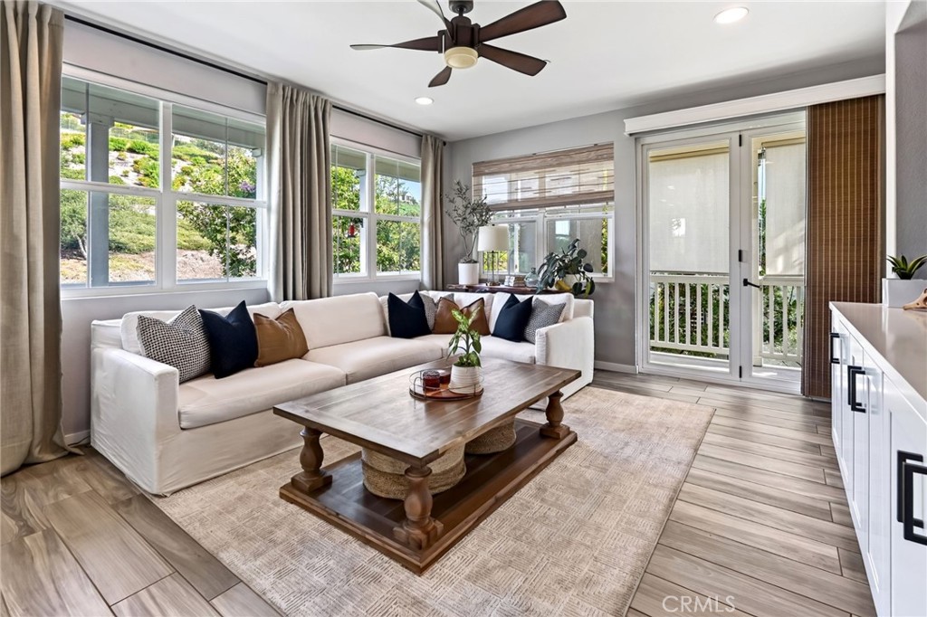 The family room has beautiful has luxury vinyl tile and designer window coverings. - 14 Marisol, Rancho Mission Viejo CA 92694 - photo 15