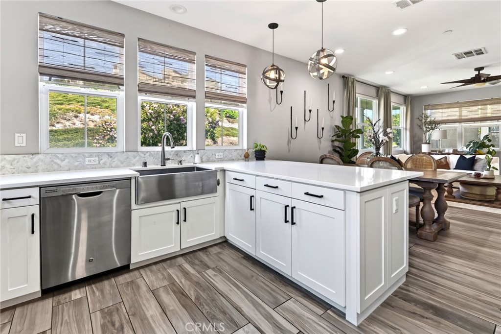 The kitchen features a farm sink, dining bar and windows that look out to the hills of Rancho Mission Viejo - 14 Marisol, Rancho Mission Viejo CA 92694 - photo 23