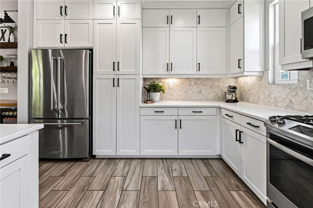 Gorgeous luxury vinyl tile can be found in the kitchen as well as stainless steel appliances & lots of storage - 14 Marisol, Rancho Mission Viejo CA 92694 - photo 26