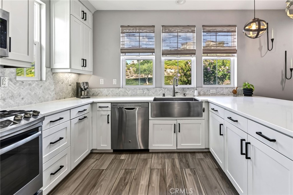 The farm sink sits just below a wall of windows in this exceptional kitchen. - 14 Marisol, Rancho Mission Viejo CA 92694 - photo 27