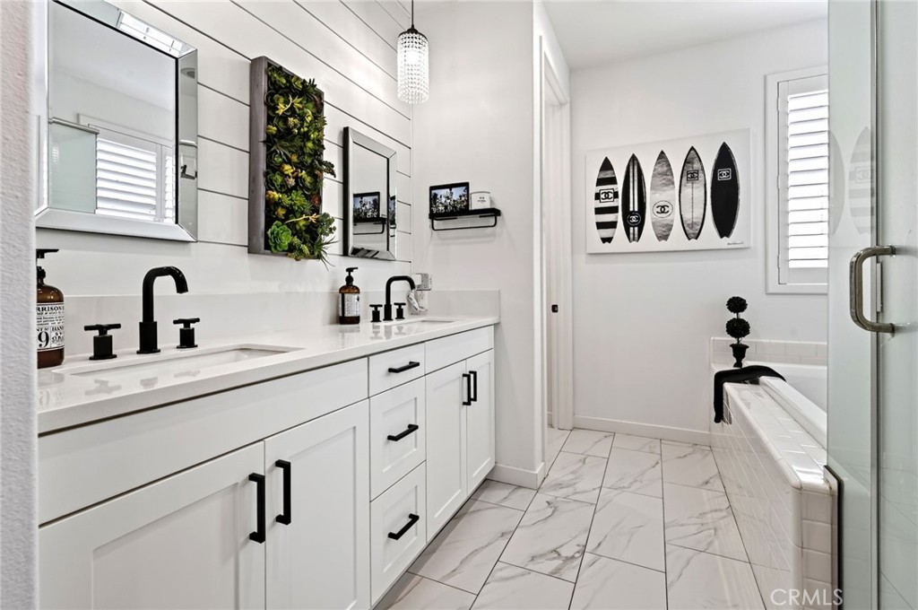 The Primary Bathroom has a double large sink vanity with elegant touches including the beveled mirrors, pendant lighting - 14 Marisol, Rancho Mission Viejo CA 92694 - photo 35
