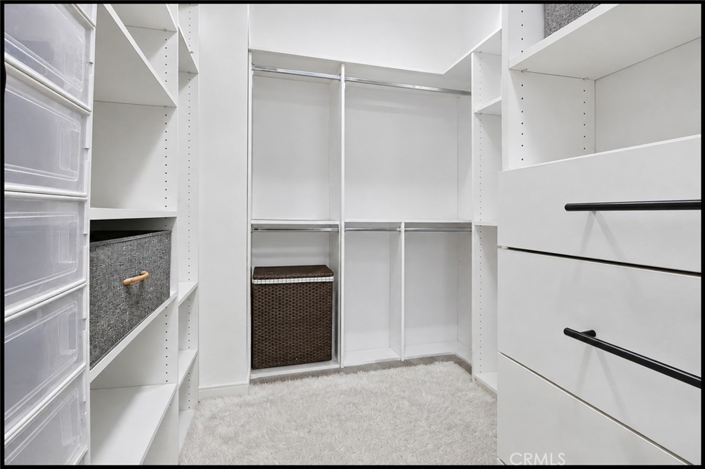 Primary Bedroom has a huge walk in closet with bins, bars, & organization drawers (AI tools used to show it empty) - 14 Marisol, Rancho Mission Viejo CA 92694 - photo 37