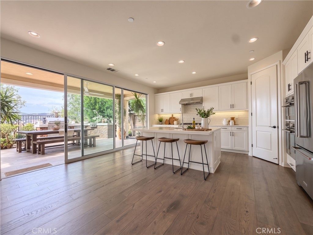Kitchen toward patio. Virtually staged with - 31 Garcilla Drive, Rancho Mission Viejo CA 92694 - photo 8