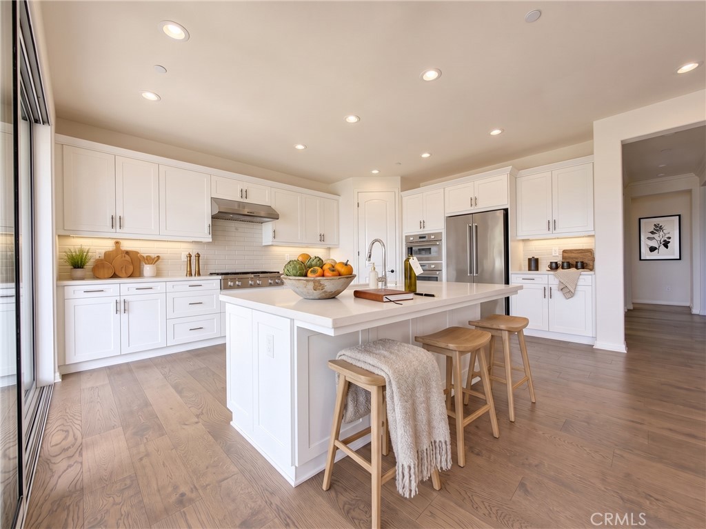Kitchen island. Virtually staged with furniture and accessories digitally added - 31 Garcilla Drive, Rancho Mission Viejo CA 92694 - photo 10