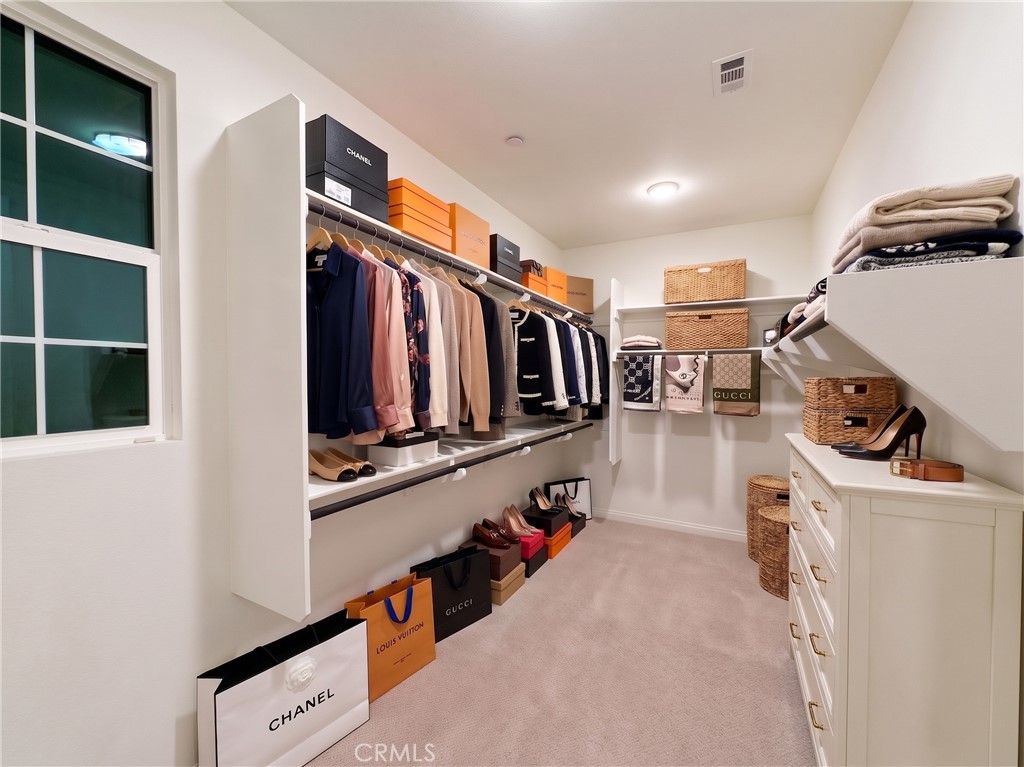 Walk-in closet. Virtually staged with furniture and decorative accessories digitally added. Enhanced unfurnished counter - 31 Garcilla Drive, Rancho Mission Viejo CA 92694 - photo 23