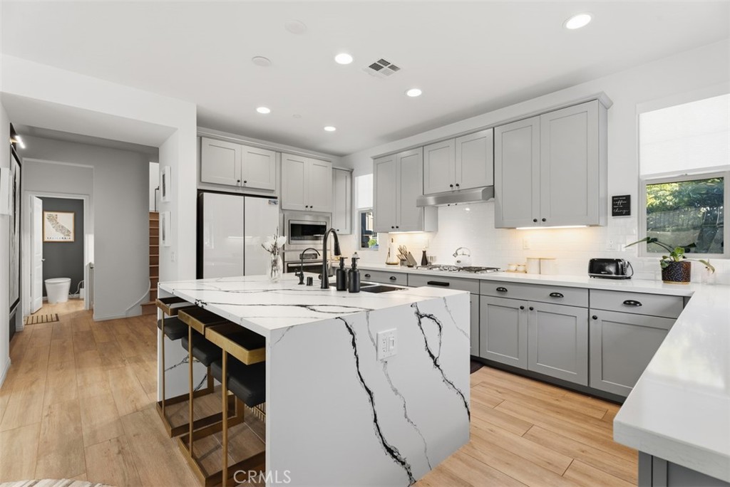 Open to the dining area and great room, the kitchen was designed for effortless entertaining, with the dramatic marble i - 33 Lomada Street, Rancho Mission Viejo CA 92694 - photo 9