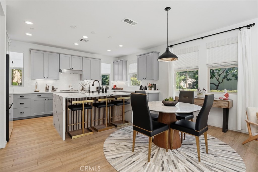 The open-concept design creates a seamless connection between the kitchen, dining area, and great room. Perfect for ente - 33 Lomada Street, Rancho Mission Viejo CA 92694 - photo 11