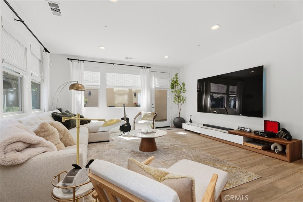 Large windows with custom window coverings enhance the space while filling the great room with beautiful natural light. - 33 Lomada Street, Rancho Mission Viejo CA 92694 - photo 13