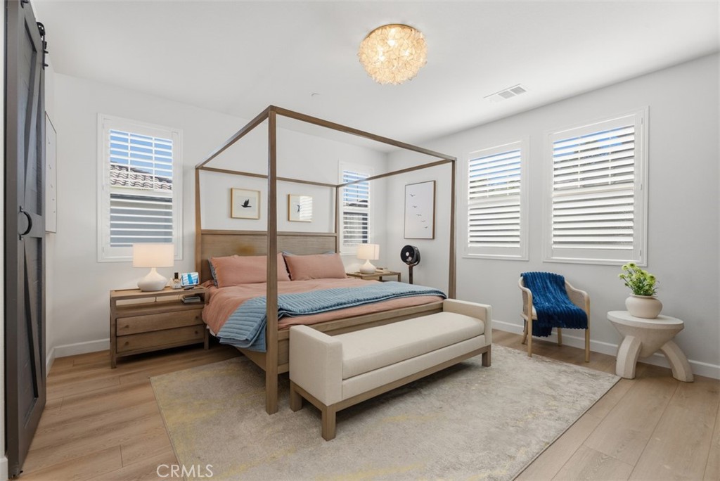 The spacious primary suite offers a relaxing retreat with room for a king-size bed and additional seating, creating the - 33 Lomada Street, Rancho Mission Viejo CA 92694 - photo 20