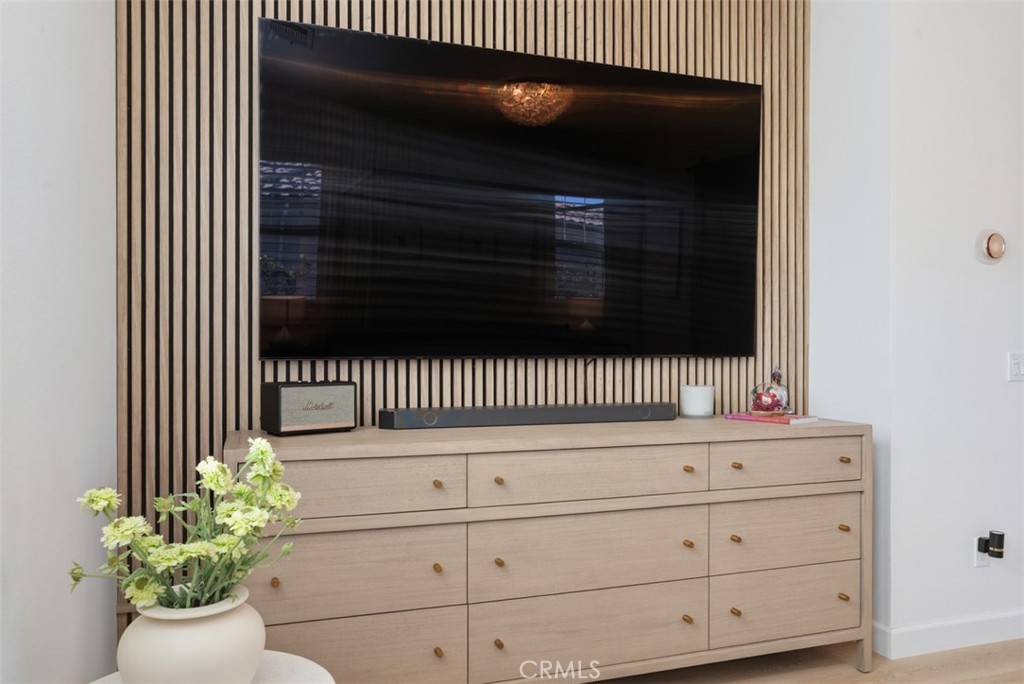 A custom wood slat accent wall creates a stunning focal point while providing the perfect backdrop for a wall-mounted te - 33 Lomada Street, Rancho Mission Viejo CA 92694 - photo 22