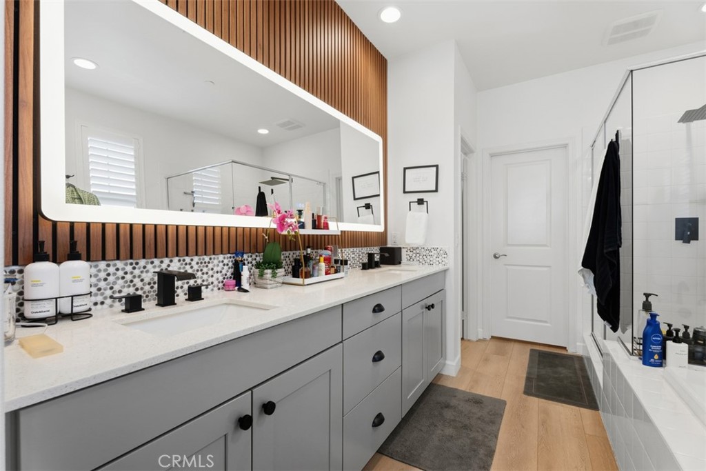 The spa-inspired primary bath features dual vanities, quartz countertops, new designer LED lighted mirror and matte blac - 33 Lomada Street, Rancho Mission Viejo CA 92694 - photo 23