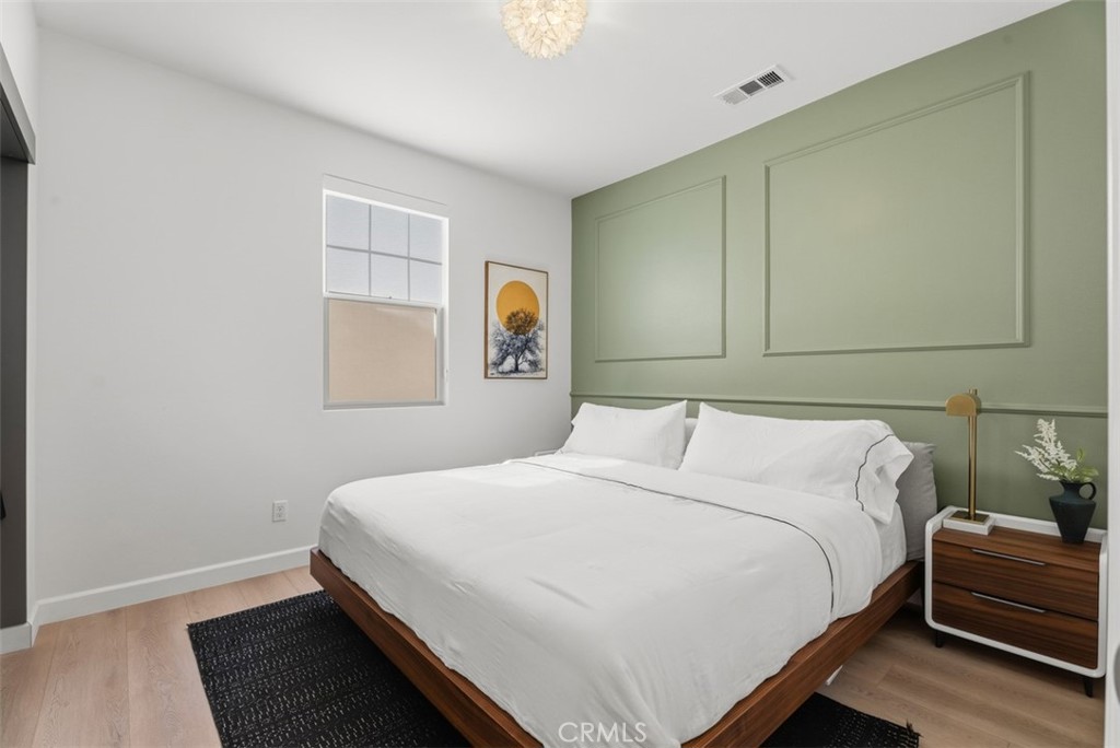 Spacious secondary bedroom featuring a custom designer accent wall, newly installed luxury vinyl plank flooring, and abu - 33 Lomada Street, Rancho Mission Viejo CA 92694 - photo 25