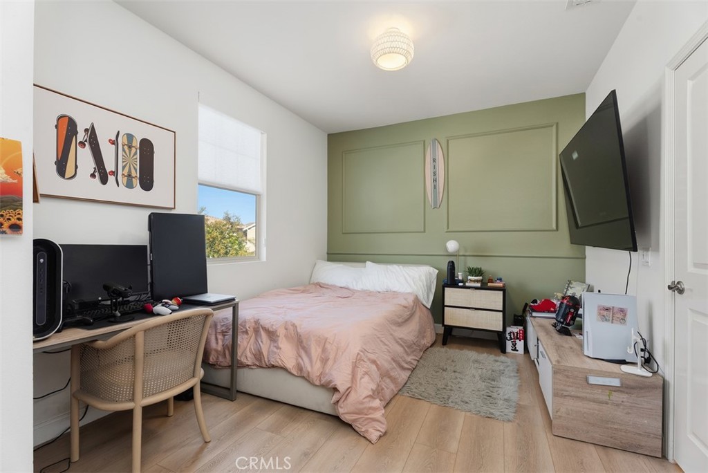 Spacious secondary bedroom with a custom designer accent wall, room for a desk or sitting area, and a walk-in closet fea - 33 Lomada Street, Rancho Mission Viejo CA 92694 - photo 26