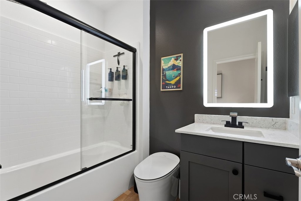 The beautifully upgraded secondary bathroom showcases a rain shower head, upgraded glass shower enclosure, smart bidet t - 33 Lomada Street, Rancho Mission Viejo CA 92694 - photo 27