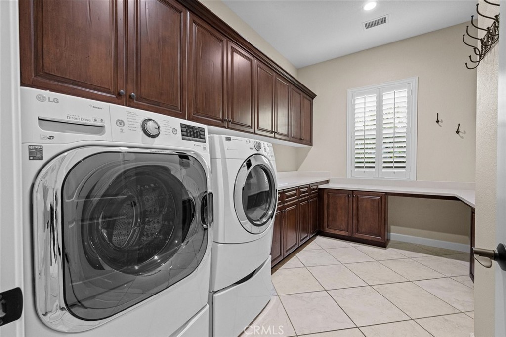 Large Laundry room with sink, linen and storage cabinets and folding counter - 9 Bahari, Rancho Mission Viejo CA 92694 - photo 33