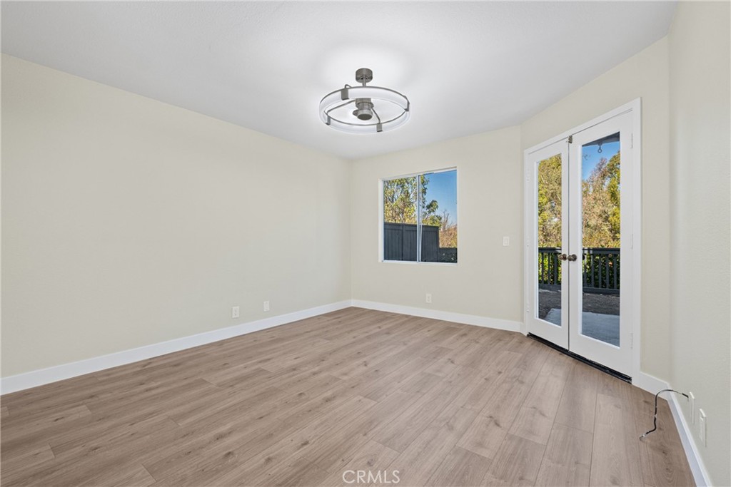 Primary bedroom with doors to the back patio. - 11 Aubrieta, Rancho Santa Margarita CA 92688 - photo 12