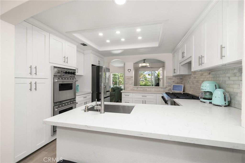 Soft Close white cabinetry, marble backsplash, quartz countertops - 14 Vista Lago, Rancho Santa Margarita CA 92688 - photo 7