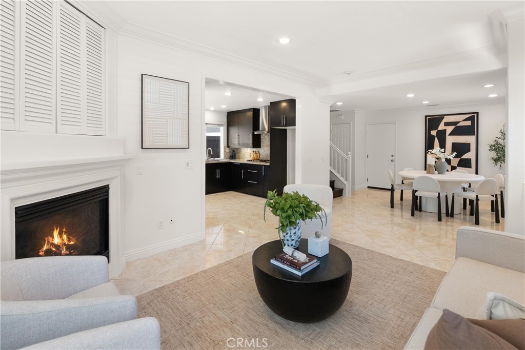 Open-concept layout seamlessly connects the living room, kitchen, dining area, and staircase, creating an ideal setting - 15 Poppyfield, Rancho Santa Margarita CA 92688 - photo 6