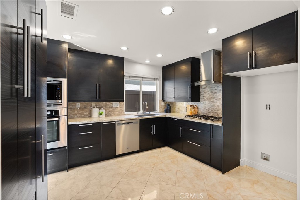 Designed for both everyday living and entertaining, the kitchen offers generous prep space, abundant cabinetry, stainles - 15 Poppyfield, Rancho Santa Margarita CA 92688 - photo 9