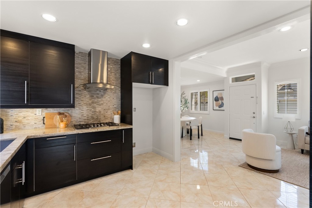 The open-concept design creates a seamless flow from the kitchen to the dining and living areas, making it easy to enter - 15 Poppyfield, Rancho Santa Margarita CA 92688 - photo 11