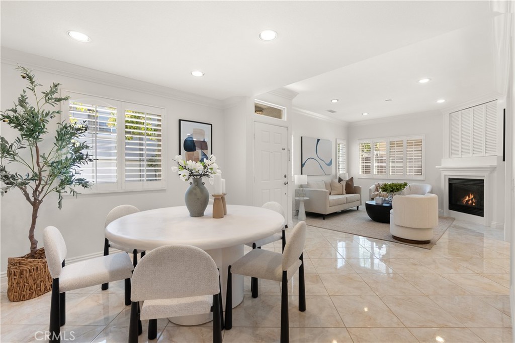 The open-concept floor plan seamlessly connects the dining area and living room, offering abundant natural light and an - 15 Poppyfield, Rancho Santa Margarita CA 92688 - photo 12