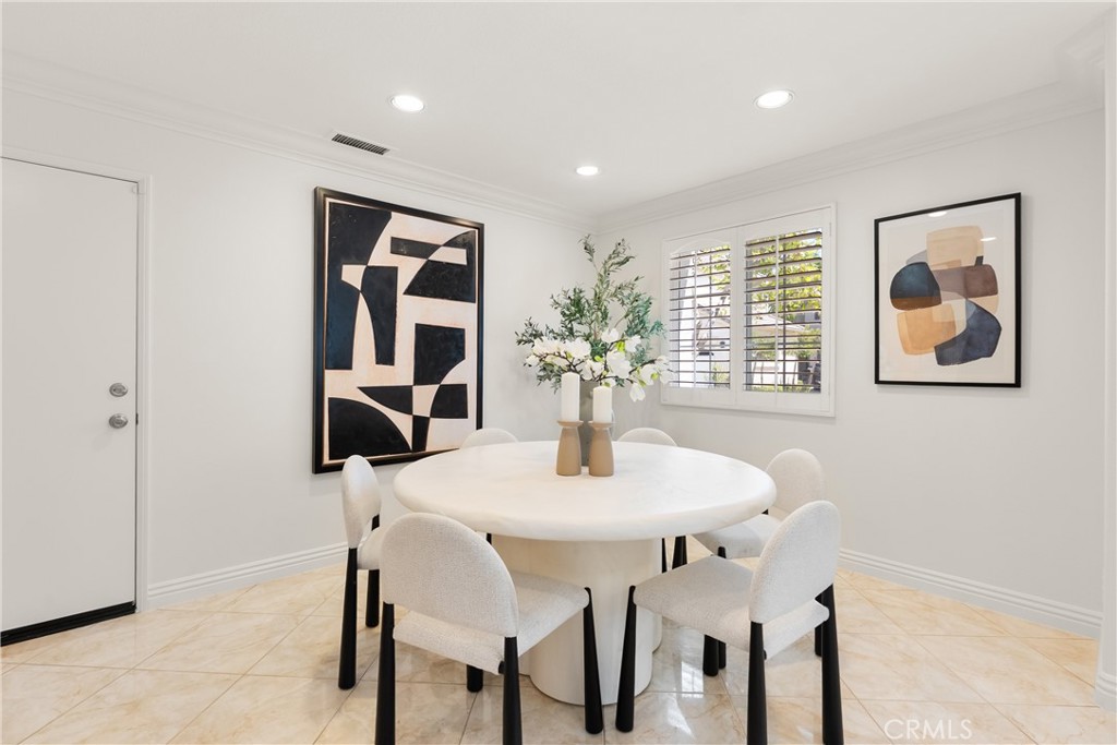Bright dining area with plantation shutters and an open layout that flows effortlessly into the main living spaces, crea - 15 Poppyfield, Rancho Santa Margarita CA 92688 - photo 13
