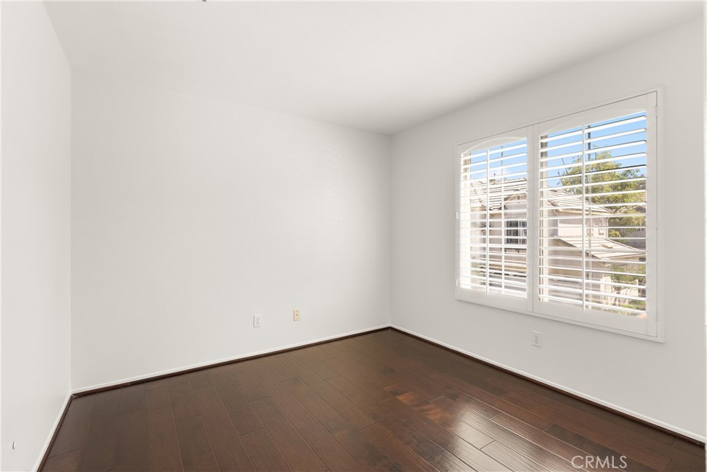 A spacious blank canvas with rich wood flooring and abundant natural light, this versatile bedroom is ready to be custom - 15 Poppyfield, Rancho Santa Margarita CA 92688 - photo 28