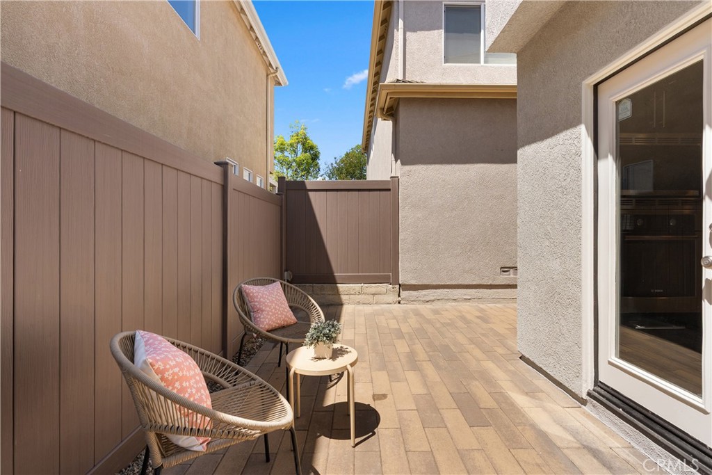 The low maintenance patio offers an inviting outdoor retreat with durable paver hardscaping, space for lounging or dinin - 15 Poppyfield, Rancho Santa Margarita CA 92688 - photo 29