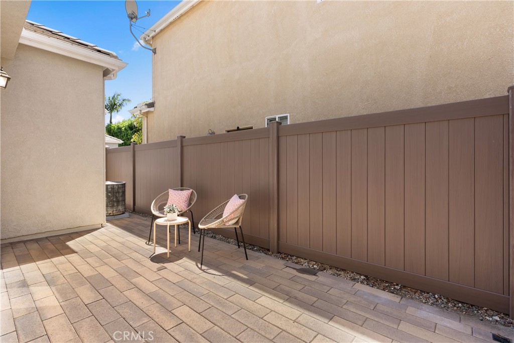 The expansive paver patio provides a versatile outdoor living space with room to lounge, entertain, or personalize to yo - 15 Poppyfield, Rancho Santa Margarita CA 92688 - photo 32
