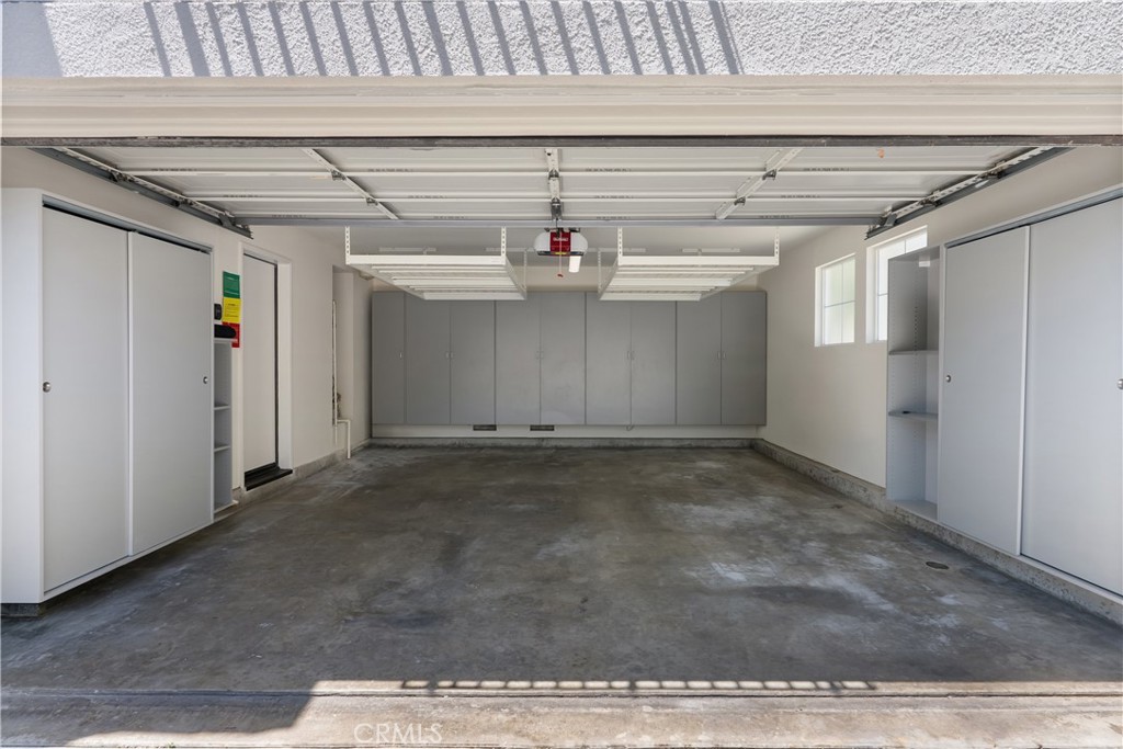 The finished two car garage is exceptionally well organized with extensive built in cabinetry, overhead storage racks, a - 15 Poppyfield, Rancho Santa Margarita CA 92688 - photo 33