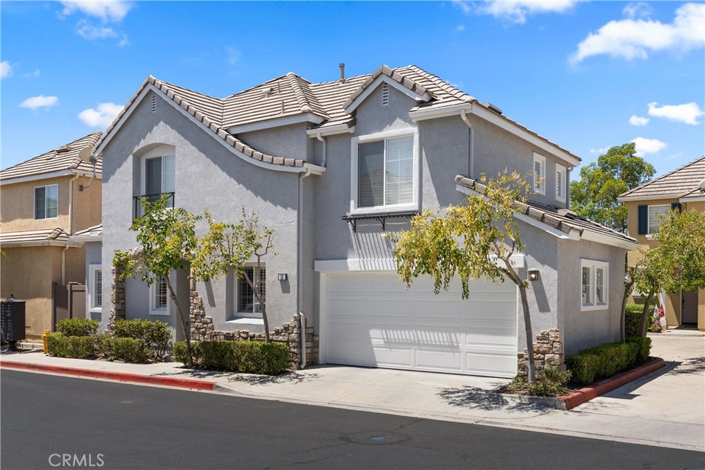 Beautifully maintained front elevation featuring mature landscaping, a two-car attached garage, and attractive curb appe - 15 Poppyfield, Rancho Santa Margarita CA 92688 - photo 35