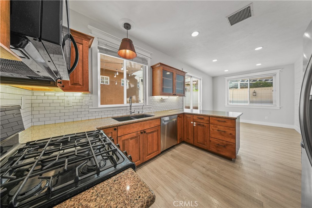 View is of the kitchen plus the adjacent kitchenette area near the window & sliding glass door - 17 Calle De Los Ninos, Rancho Santa Margarita CA 92688 - photo 14