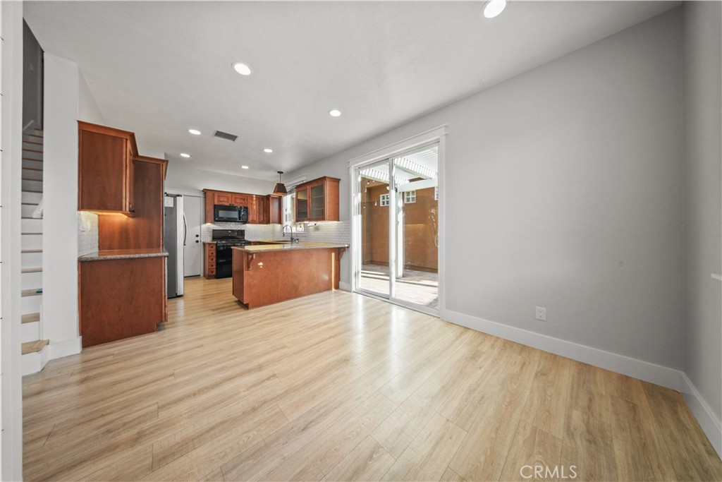View is from the kitchenette area looking towards the glass doors & kitchen - 17 Calle De Los Ninos, Rancho Santa Margarita CA 92688 - photo 16