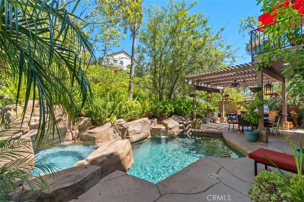 The resort style backyard retreat features a custom salt water pool with cascading rock waterfall, spa, and lush mature - 21792 Hermosa Lane, Rancho Santa Margarita CA 92679 - photo 4