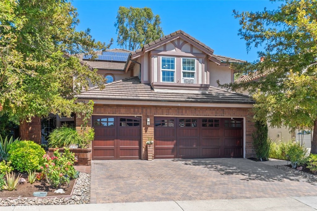 The impressive curb appeal features a custom brick paver driveway and approach, insulated craftsman style wood garage do - 21792 Hermosa Lane, Rancho Santa Margarita CA 92679 - photo 6