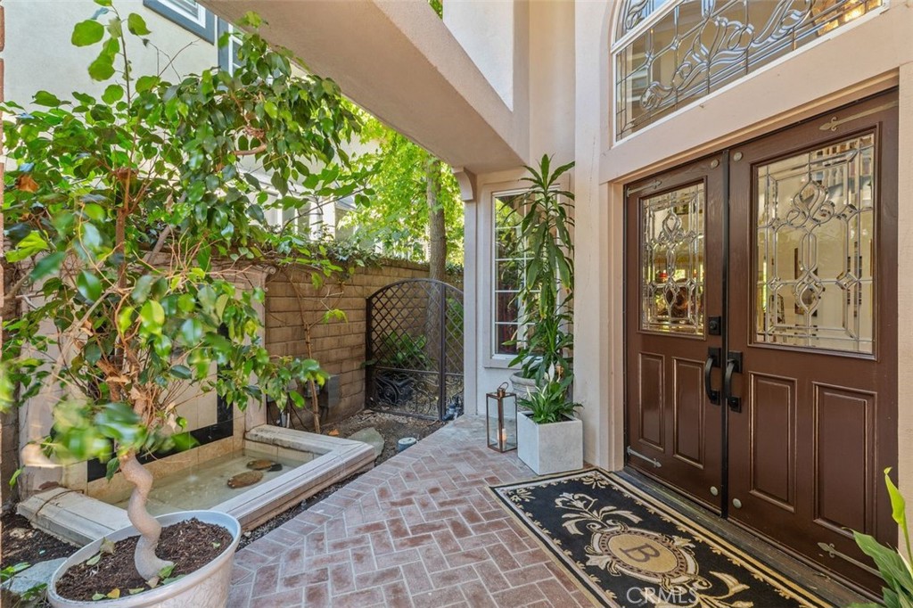 A private courtyard with custom brick paver walkway and serene fountain welcomes you home through dramatic double doors - 21792 Hermosa Lane, Rancho Santa Margarita CA 92679 - photo 7
