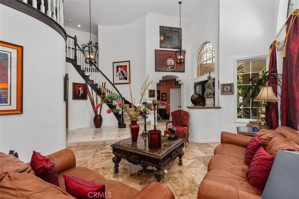 The dramatic two story great room impresses with soaring vaulted ceilings, elegant travertine tile floors, crown molding - 21792 Hermosa Lane, Rancho Santa Margarita CA 92679 - photo 9