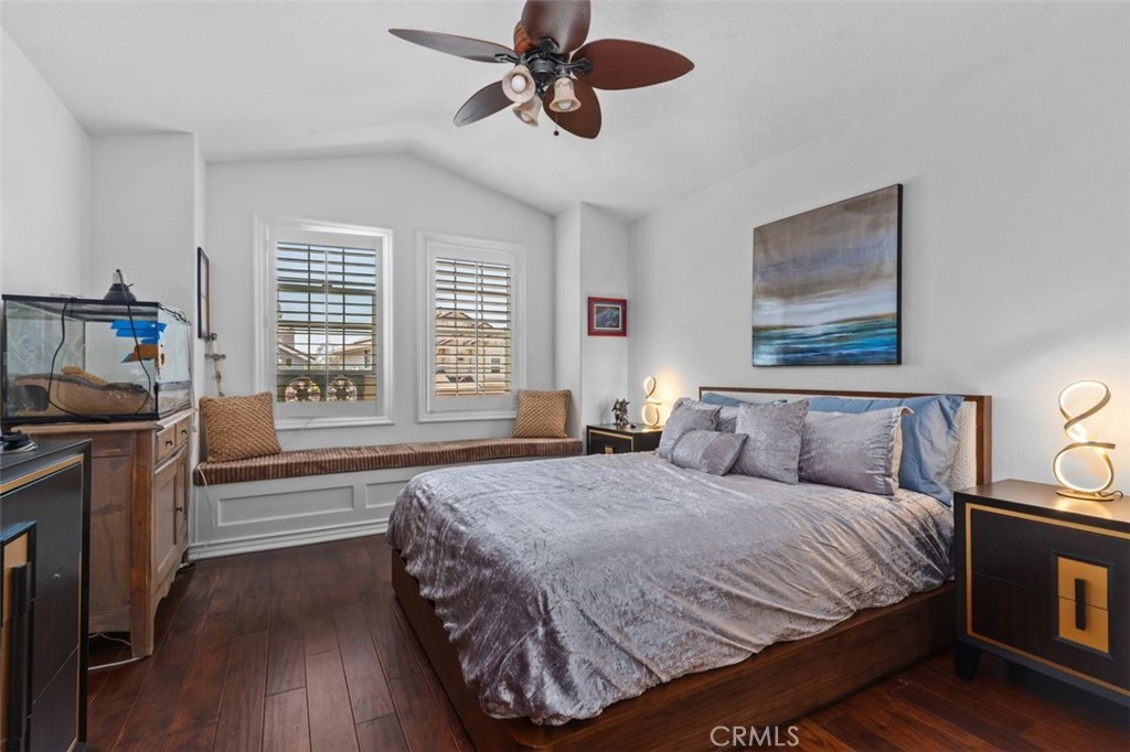 This bright and airy upper level bedroom features warm hardwood floors, vaulted ceiling, plantation shutters, a ceiling - 21792 Hermosa Lane, Rancho Santa Margarita CA 92679 - photo 31