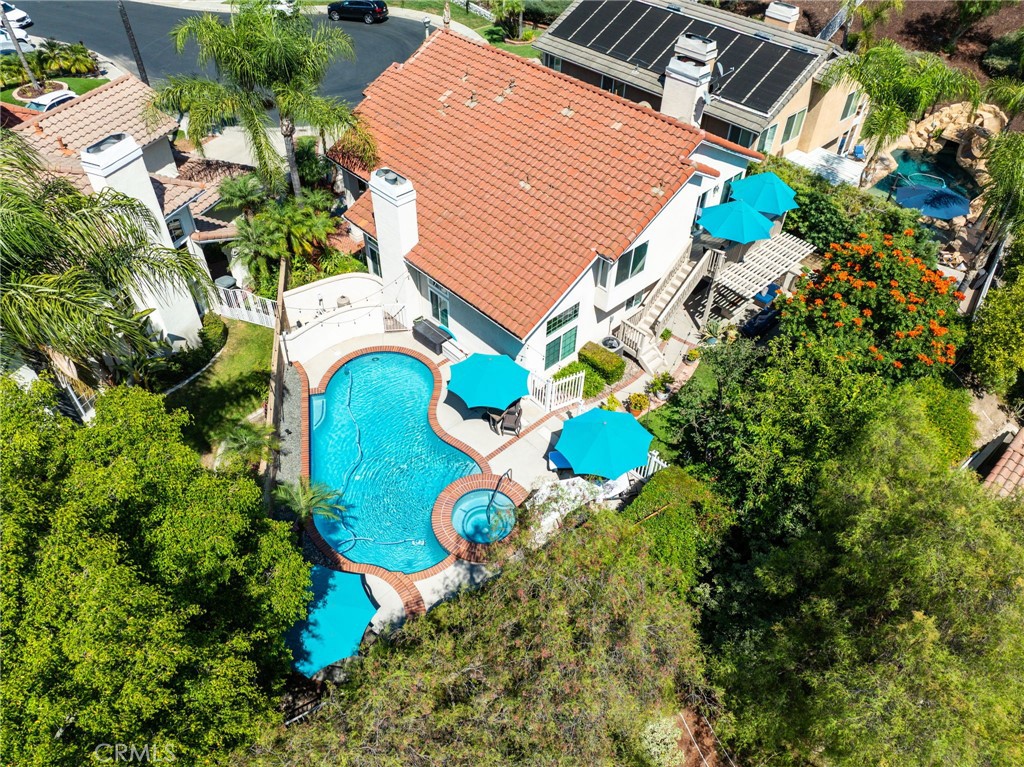 Overhead view of the backyard oasis featuring a sparkling pool and outdoor living spaces. - 21861 Caminito Drive, Rancho Santa Margarita CA 92679 - photo 1