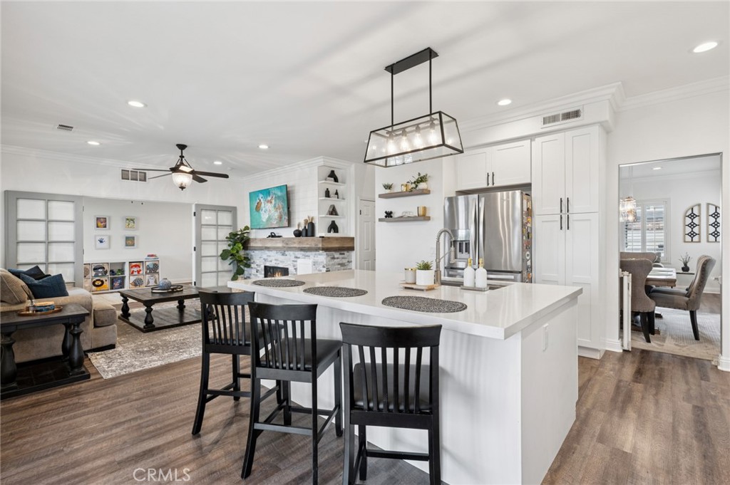 Elegant kitchen with shaker-style cabinetry, quartz countertops, and stainless-steel appliances open to family room. - 23 Wayfaire, Rancho Santa Margarita CA 92688 - photo 1