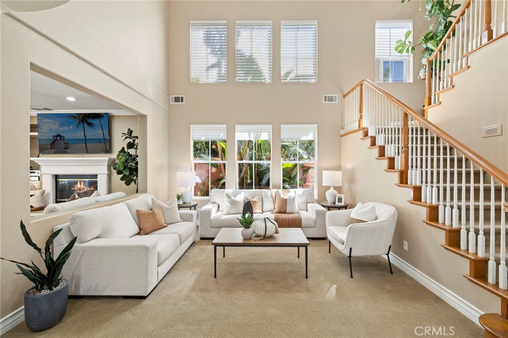 Step inside to a light-filled living room with soaring ceilings and an abundance of windows. - 30 Acanthus, Rancho Santa Margarita CA 92688 - photo 2