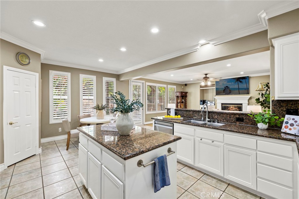 The kitchen features white cabinetry and beautiful granite countertops. - 30 Acanthus, Rancho Santa Margarita CA 92688 - photo 8