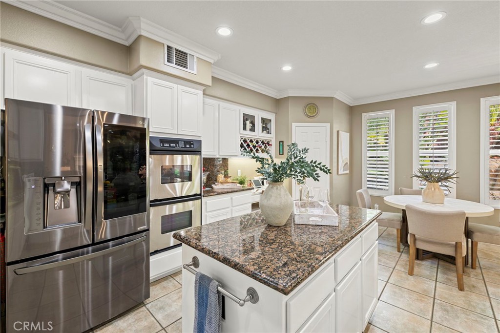 The kitchen features stainless steel appliances, a five-burner gas range and double ovens. - 30 Acanthus, Rancho Santa Margarita CA 92688 - photo 10