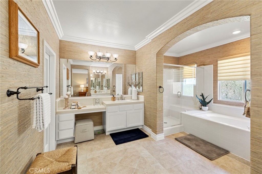 The primary bathroom features dual vanities, a soaking tub, and a separate walk-in shower. - 30 Acanthus, Rancho Santa Margarita CA 92688 - photo 23